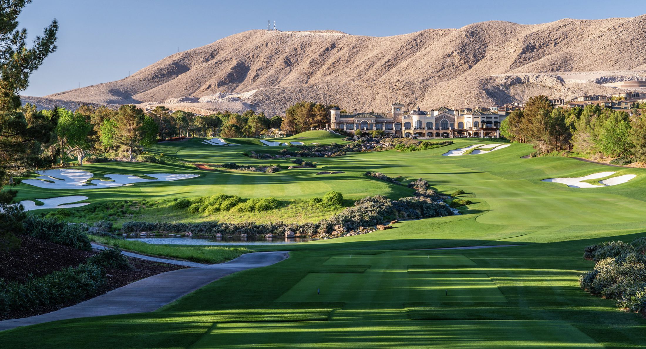 Panoramic view of the Robert Trent Jones course with lake, desert landscaping and mountains